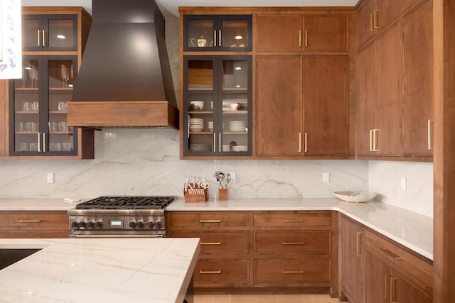 8159 Riverside Dr, Powell, OH 43065 - kitchen featuring custom exhaust hood, high end stainless steel range, decorative backsplash, and light stone counters