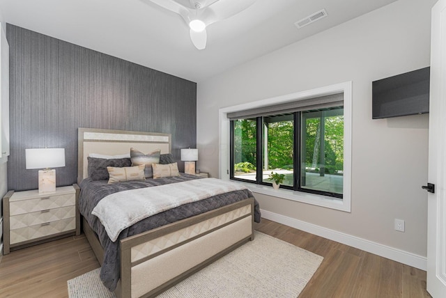 8159 Riverside Dr, Powell, OH 43065 - bedroom with an accent wall, wood finished floors, baseboards, and ceiling fan