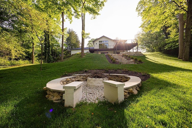 8159 Riverside Dr, Powell, OH 43065 - view of green lawn featuring a fire pit and a wooden deck
