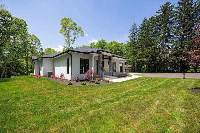 8159 Riverside Dr, Powell, OH 43065 - view of front of house with stucco siding, a front yard, and cooling unit