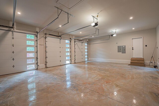 8159 Riverside Dr, Powell, OH 43065 - garage featuring a garage door opener, electric panel, baseboards, and recessed lighting