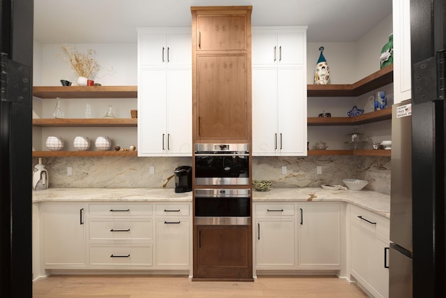 8159 Riverside Dr, Powell, OH 43065 - kitchen with open shelves, light wood-style flooring, tasteful backsplash, and appliances with stainless steel finishes