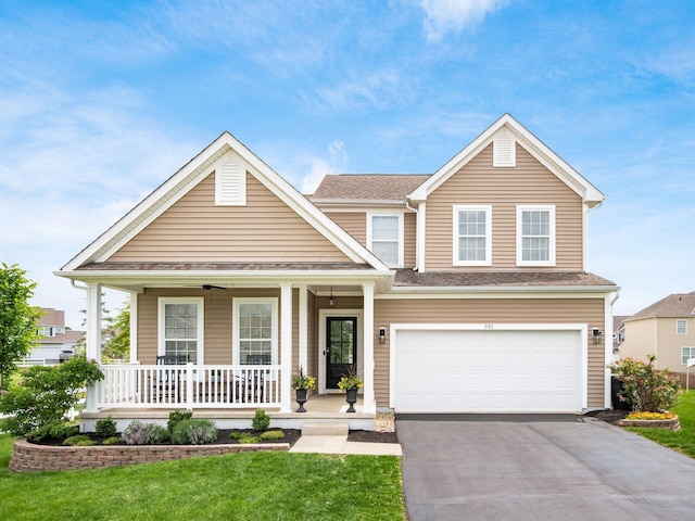 593 Summer Tree Loop, Marysville, OH 43040 - view of front facade with covered porch, asphalt driveway, a front yard, and an attached garage