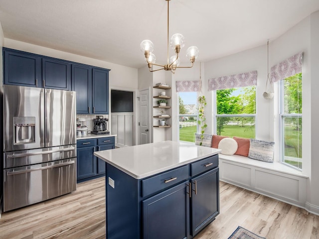 593 Summer Tree Loop, Marysville, OH 43040 - kitchen featuring stainless steel fridge with ice dispenser, blue cabinetry, light countertops, light wood-type flooring, and a chandelier