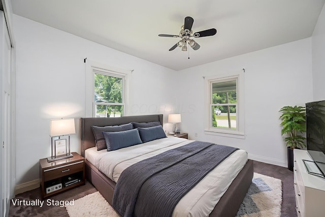4469 Lancaster Ave, Columbus, OH 43207 - bedroom featuring multiple windows, dark colored carpet, and a ceiling fan
