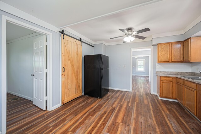 4469 Lancaster Ave, Columbus, OH 43207 - kitchen with freestanding refrigerator, dark wood finished floors, ceiling fan, and a barn door