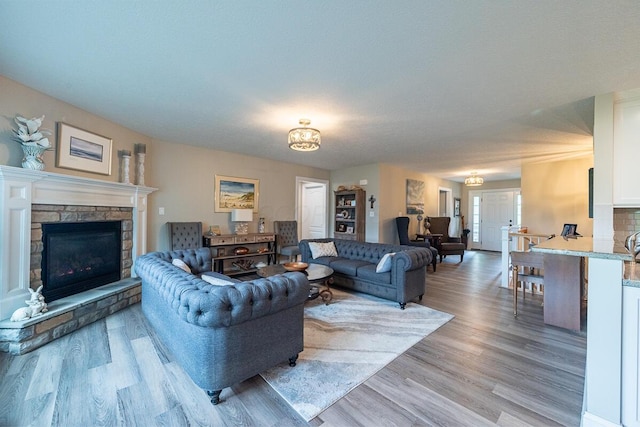 10641 Arrowwood Dr, Plain City, OH 43064 - living area with light wood finished floors, a fireplace, and a chandelier
