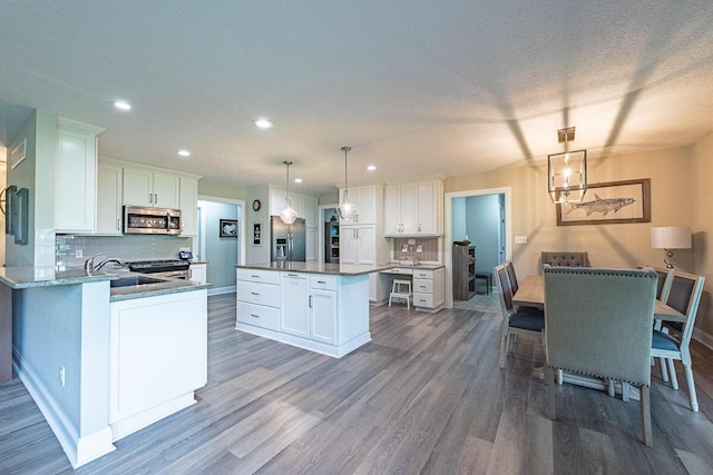 10641 Arrowwood Dr, Plain City, OH 43064 - kitchen featuring stainless steel appliances, dark wood finished floors, backsplash, white cabinetry, and recessed lighting