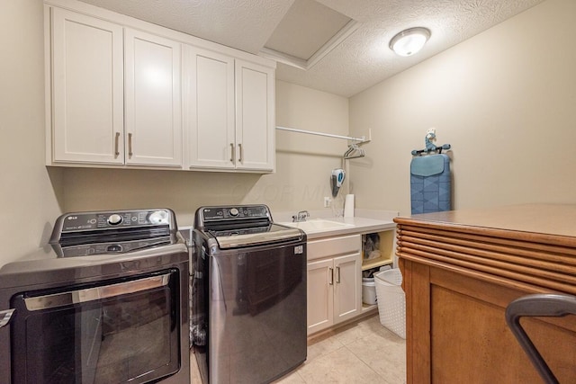 10641 Arrowwood Dr, Plain City, OH 43064 - washroom featuring cabinet space, washing machine and dryer, a textured ceiling, and light tile patterned flooring
