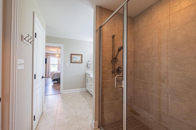 10641 Arrowwood Dr, Plain City, OH 43064 - bathroom featuring a shower stall, vanity, tile patterned floors, and baseboards