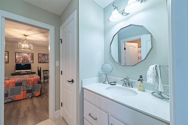10641 Arrowwood Dr, Plain City, OH 43064 - bathroom featuring vanity, a chandelier, and wood finished floors