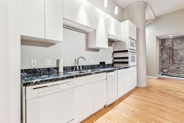 106 N High St Unit 303, Columbus, OH 43215 - kitchen with white appliances, a sink, white cabinetry, light wood-type flooring, and dark stone countertops