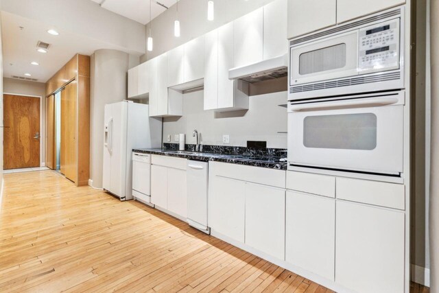 106 N High St Unit 303, Columbus, OH 43215 - kitchen with white appliances, a sink, light wood-type flooring, white cabinetry, and recessed lighting