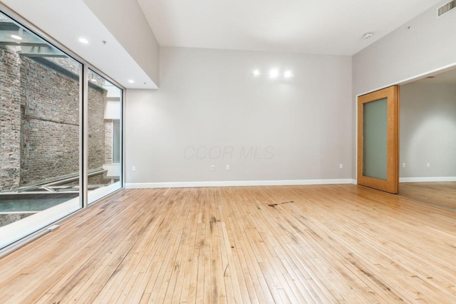 106 N High St Unit 303, Columbus, OH 43215 - empty room featuring hardwood / wood-style floors, baseboards, and a smoke detector