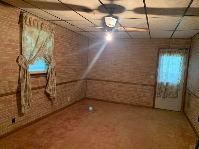 101 Gale Ct, Circleville, OH 43113 - carpeted spare room with brick wall, ceiling fan, and a paneled ceiling