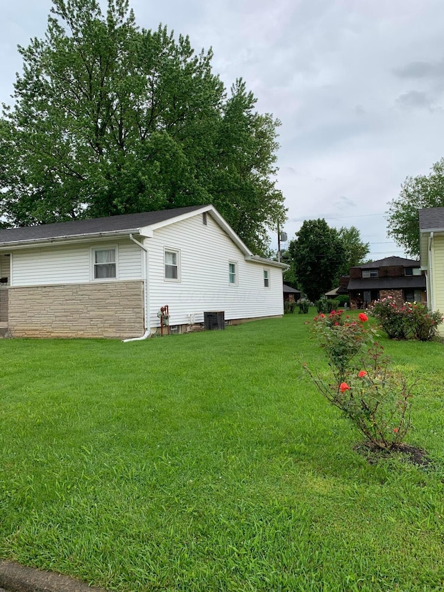 101 Gale Ct, Circleville, OH 43113 - view of home's exterior with central AC, stone siding, and a lawn