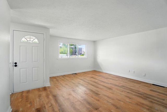 1410 E Dublin Granville Rd, Columbus, OH 43229 - entryway with wood finished floors, baseboards, and a textured ceiling