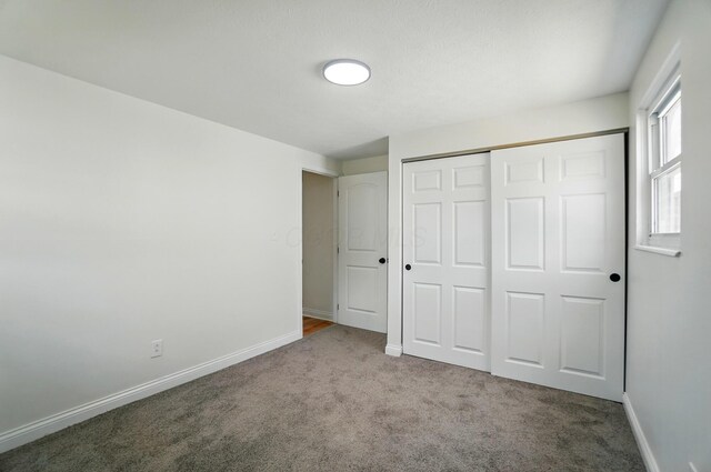 1410 E Dublin Granville Rd, Columbus, OH 43229 - unfurnished bedroom featuring carpet flooring, a closet, and baseboards