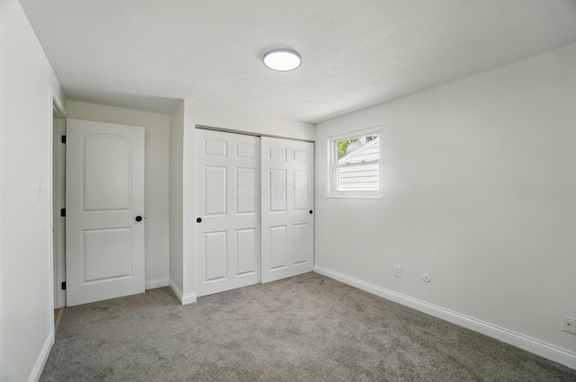 1410 E Dublin Granville Rd, Columbus, OH 43229 - unfurnished bedroom with carpet flooring, baseboards, a closet, and a textured ceiling