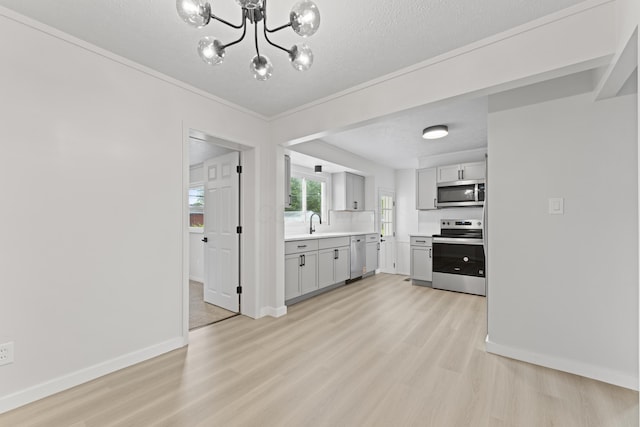 1116 S Yearling Rd, Columbus, OH 43227 - kitchen featuring stainless steel appliances, light wood-type flooring, light countertops, a chandelier, and a textured ceiling