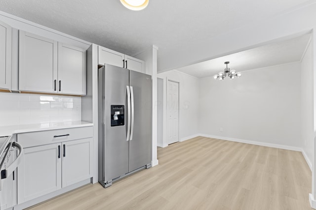 1116 S Yearling Rd, Columbus, OH 43227 - kitchen with stainless steel fridge with ice dispenser, light wood-style floors, a chandelier, decorative backsplash, and light countertops