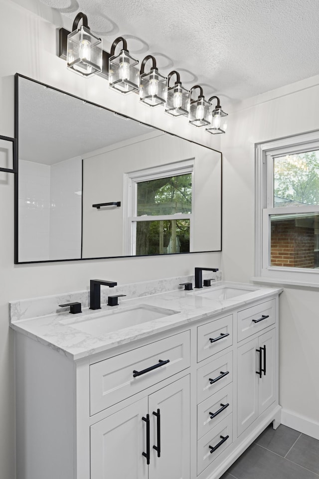 1116 S Yearling Rd, Columbus, OH 43227 - bathroom with tile patterned floors, double vanity, and a textured ceiling
