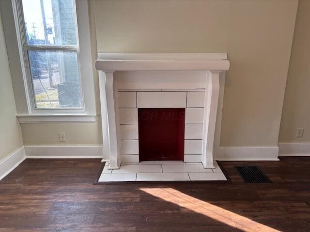 411 Berkeley Rd, Columbus, OH 43205 - detailed view of wood finished floors, baseboards, and a tiled fireplace