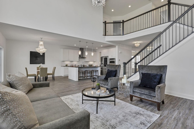 7578 Hastings St, Pickerington, OH 43147 - living room with a towering ceiling, dark wood-style floors, baseboards, a chandelier, and recessed lighting