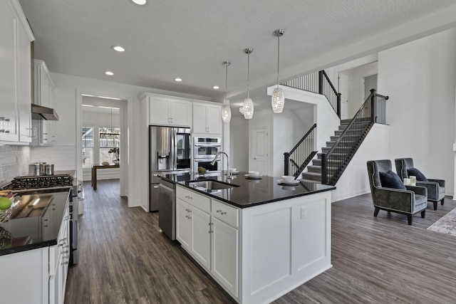 7578 Hastings St, Pickerington, OH 43147 - kitchen featuring appliances with stainless steel finishes, a sink, dark countertops, dark wood finished floors, and recessed lighting