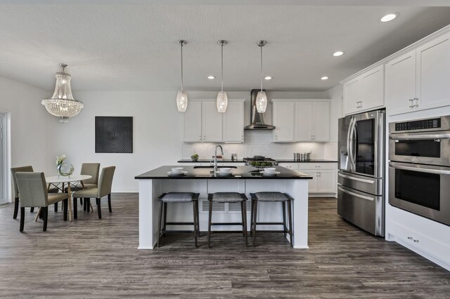 7578 Hastings St, Pickerington, OH 43147 - kitchen with appliances with stainless steel finishes, dark countertops, a breakfast bar, a chandelier, and backsplash