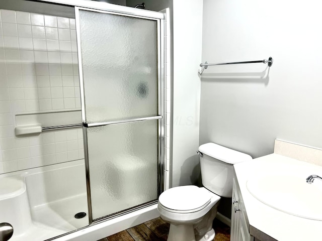 4960 Ivyvine Blvd, Dublin, OH 43016 - bathroom with a shower stall, vanity, toilet, and wood finished floors