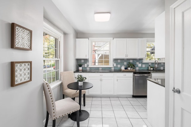 1052 Geers Ave, Columbus, OH 43206 - kitchen with dishwasher, decorative backsplash, dark countertops, and white cabinets