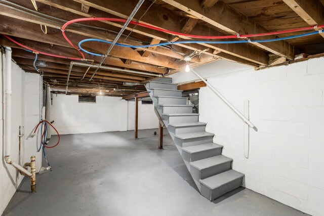 1052 Geers Ave, Columbus, OH 43206 - unfinished basement featuring stairs and concrete block wall