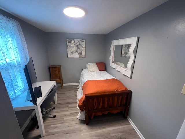 1119 Poplar St, Nelsonville, OH 45764 - bedroom featuring light wood finished floors, baseboards, and a desk
