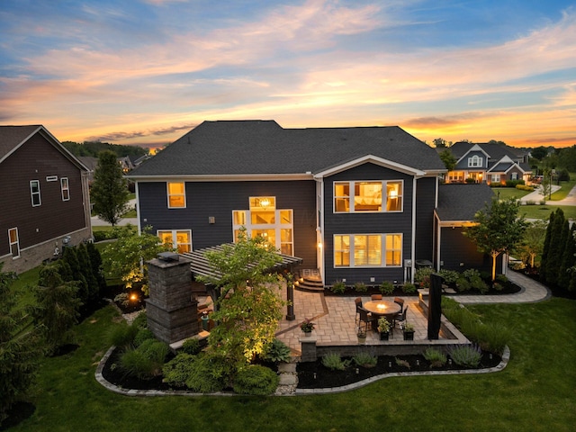3624 Sparrow Ct, Hilliard, OH 43026 - back of property at dusk with a patio, a lawn, and an outdoor fire pit