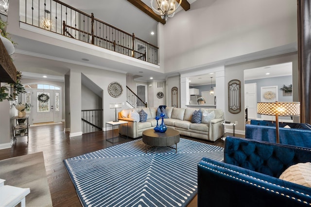 3624 Sparrow Ct, Hilliard, OH 43026 - living area featuring stairs, wood finished floors, ornamental molding, a towering ceiling, and baseboards