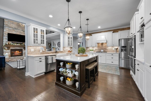 3624 Sparrow Ct, Hilliard, OH 43026 - kitchen with stainless steel appliances, a kitchen island, open shelves, light countertops, and glass insert cabinets