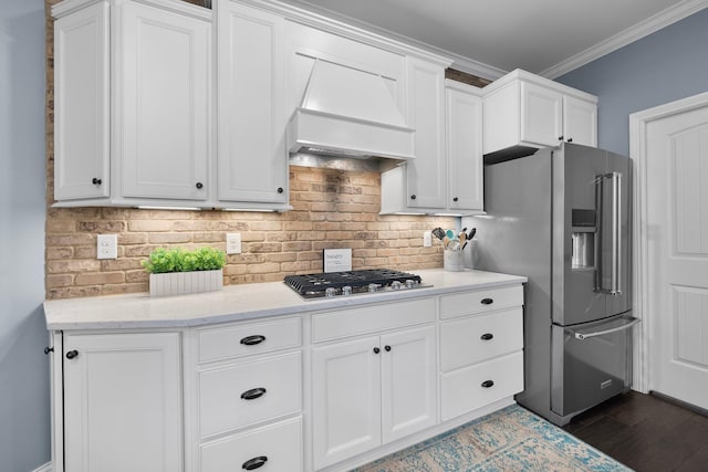 3624 Sparrow Ct, Hilliard, OH 43026 - kitchen featuring stainless steel appliances, premium range hood, tasteful backsplash, white cabinets, and ornamental molding