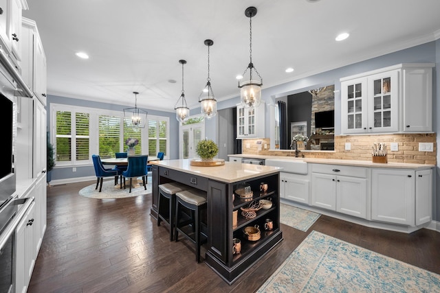 3624 Sparrow Ct, Hilliard, OH 43026 - kitchen with a kitchen island, a chandelier, white cabinets, decorative backsplash, and recessed lighting