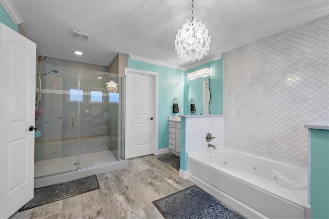3624 Sparrow Ct, Hilliard, OH 43026 - bathroom with vanity, a stall shower, a jetted tub, ornamental molding, and a chandelier