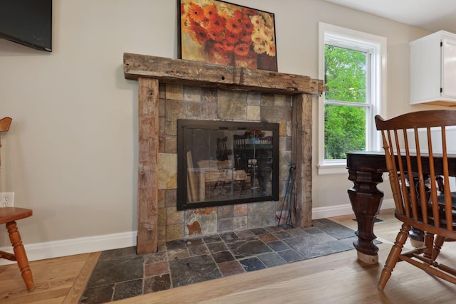 7700 State Route 61, Sunbury, OH 43074 - detailed view of baseboards, a tile fireplace, and wood finished floors