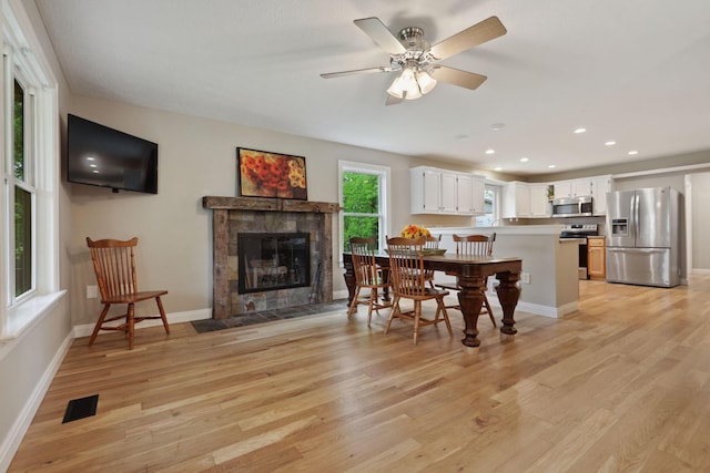 7700 State Route 61, Sunbury, OH 43074 - dining space with light wood-type flooring, baseboards, a fireplace, recessed lighting, and ceiling fan