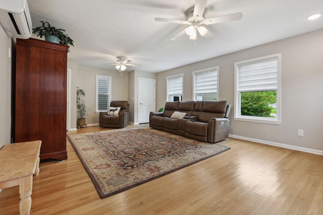 7700 State Route 61, Sunbury, OH 43074 - living room featuring a wall unit AC, a ceiling fan, light wood-style flooring, baseboards, and recessed lighting