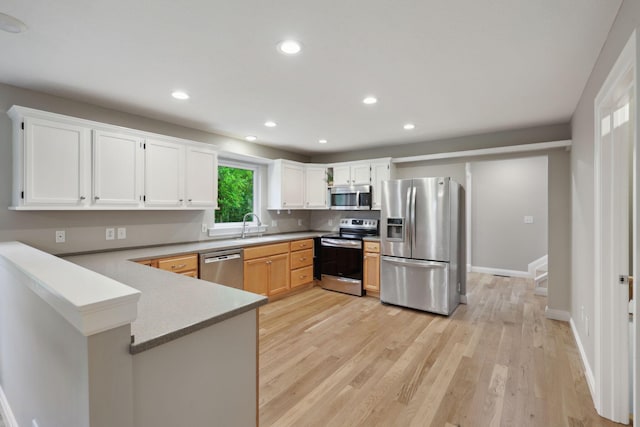 7700 State Route 61, Sunbury, OH 43074 - kitchen with stainless steel appliances, a peninsula, recessed lighting, light wood finished floors, and baseboards