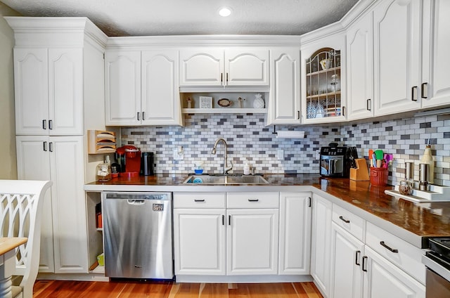 8448 Blue Lake Ave, Galloway, OH 43119 - kitchen featuring dishwasher, a sink, dark countertops, white cabinets, and glass insert cabinets