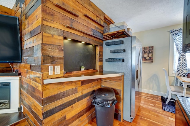 8448 Blue Lake Ave, Galloway, OH 43119 - kitchen with stainless steel fridge with ice dispenser, wood finished floors, baseboards, and a textured ceiling