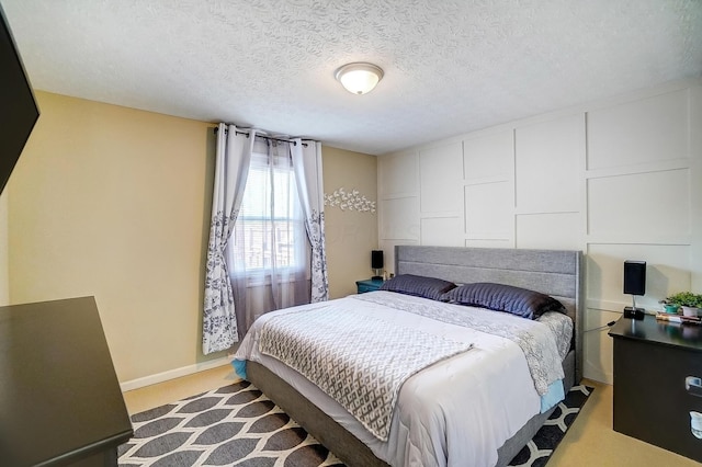 8448 Blue Lake Ave, Galloway, OH 43119 - bedroom with baseboards, light carpet, and a textured ceiling
