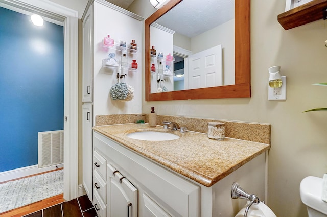 8448 Blue Lake Ave, Galloway, OH 43119 - bathroom with vanity, wood finished floors, toilet, and baseboards