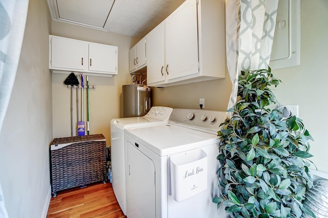 8448 Blue Lake Ave, Galloway, OH 43119 - washroom featuring electric water heater, independent washer and dryer, light wood-style floors, electric panel, and cabinet space