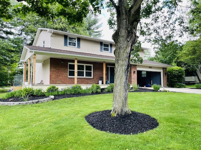 460 Blandings Ct, Worthington, OH 43085 - view of front of property with an attached garage, a front lawn, brick siding, stucco siding, and driveway